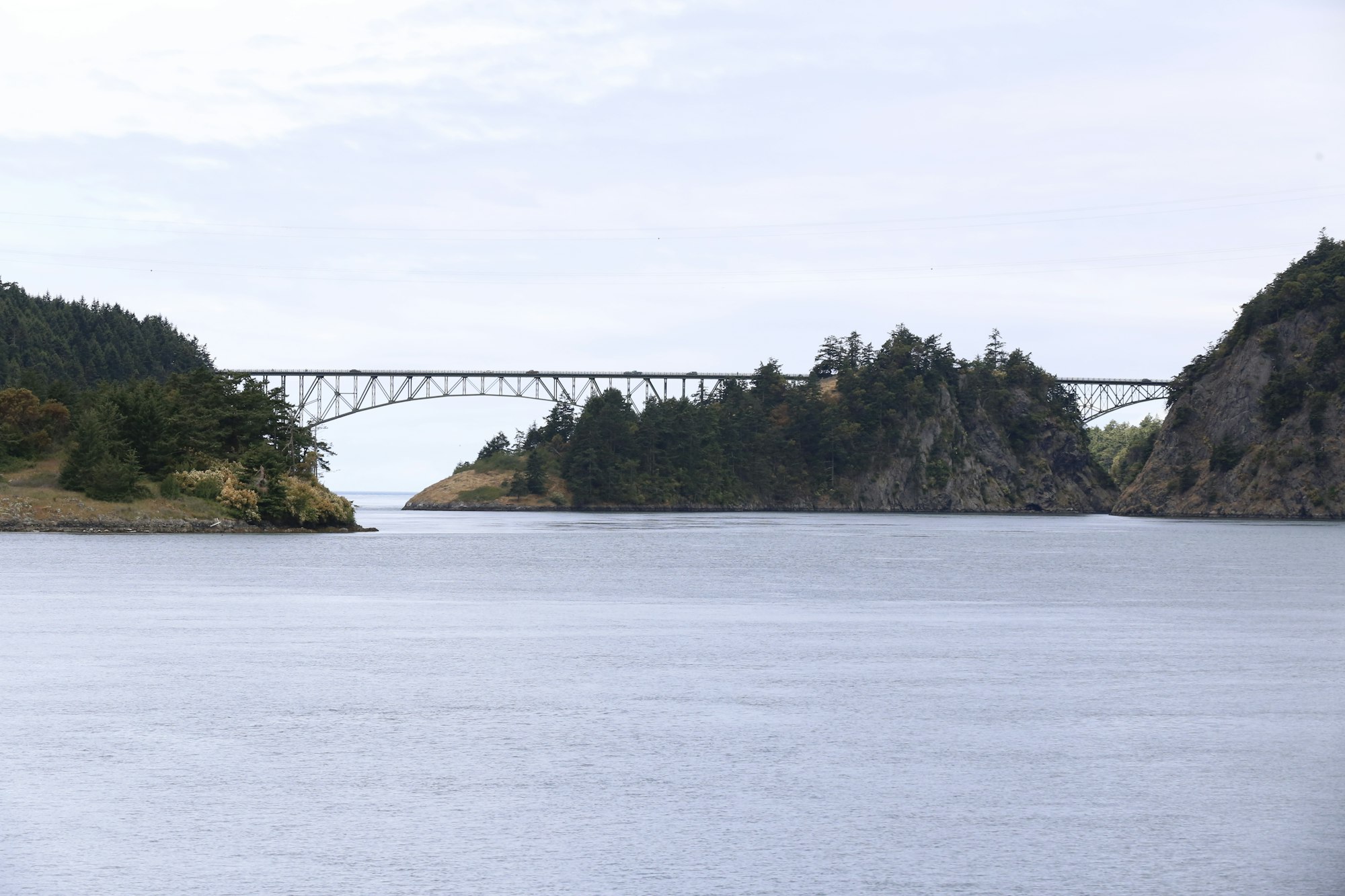 Deception Pass on Whidbey Island, with the bridge in the distance over calm water